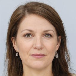 Joyful white adult female with long  brown hair and grey eyes