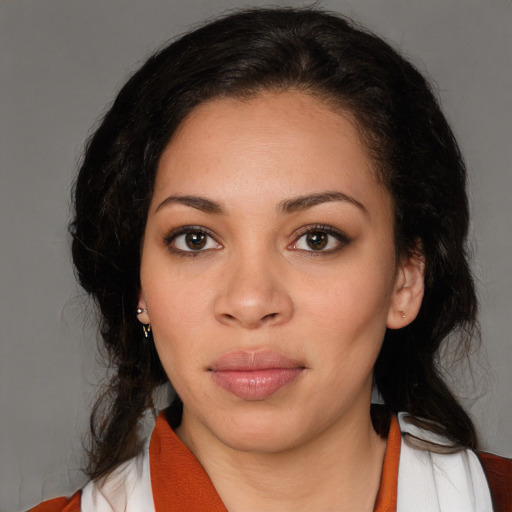 Joyful latino young-adult female with medium  brown hair and brown eyes
