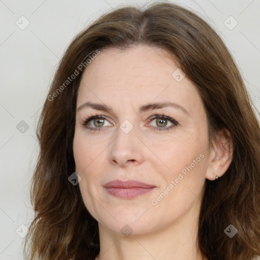 Joyful white adult female with long  brown hair and brown eyes