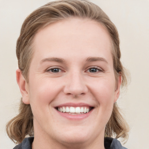 Joyful white young-adult female with medium  brown hair and blue eyes