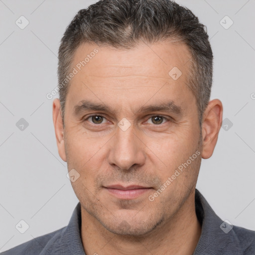 Joyful white adult male with short  brown hair and brown eyes