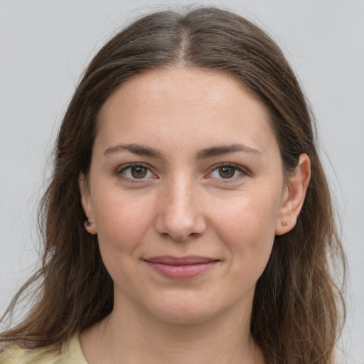 Joyful white young-adult female with long  brown hair and grey eyes
