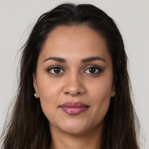Joyful latino young-adult female with long  brown hair and brown eyes