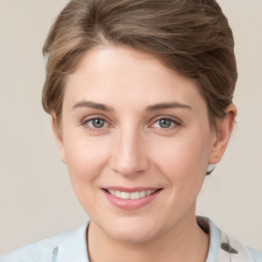 Joyful white young-adult female with short  brown hair and grey eyes