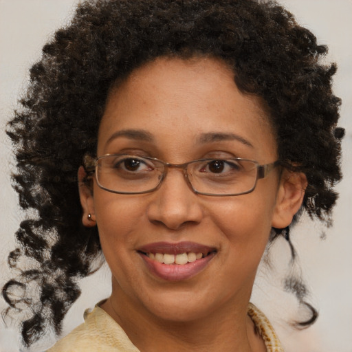 Joyful black adult female with medium  brown hair and brown eyes