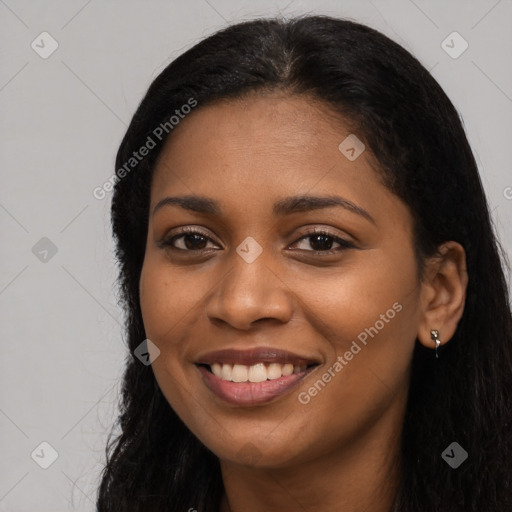 Joyful black young-adult female with long  black hair and brown eyes