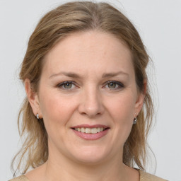 Joyful white adult female with medium  brown hair and grey eyes