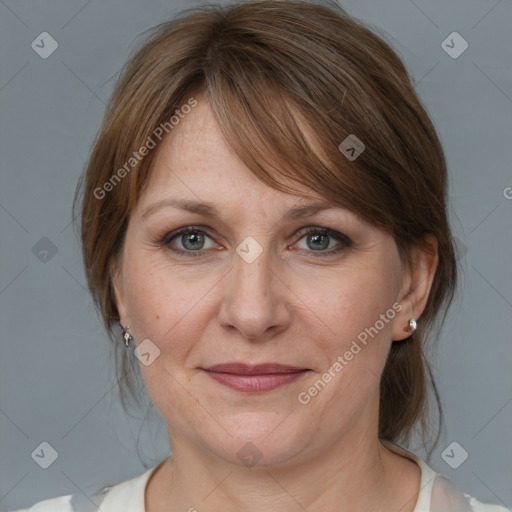 Joyful white adult female with medium  brown hair and grey eyes