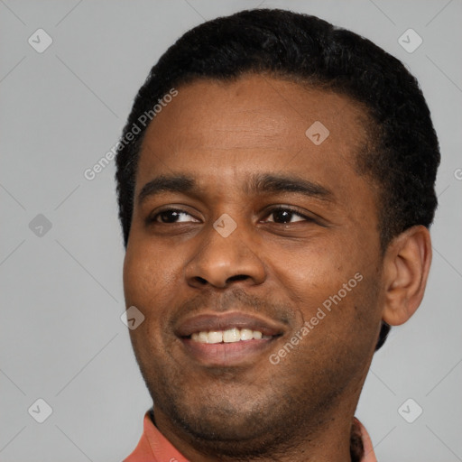 Joyful black young-adult male with short  black hair and brown eyes