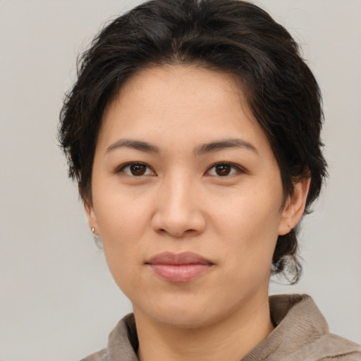Joyful asian young-adult female with medium  brown hair and brown eyes
