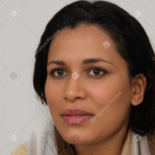 Joyful black young-adult female with long  black hair and brown eyes