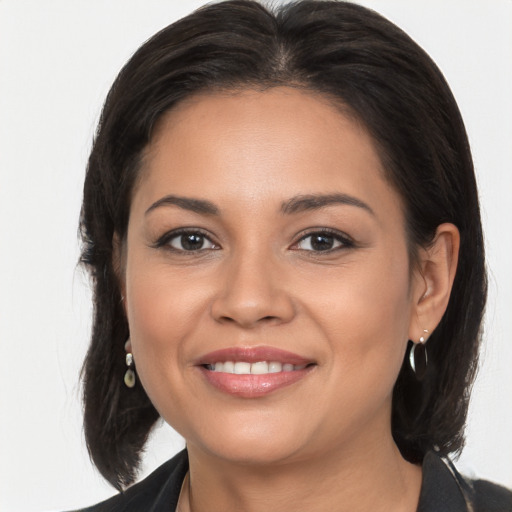 Joyful latino young-adult female with medium  brown hair and brown eyes