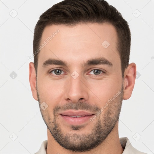 Joyful white young-adult male with short  brown hair and brown eyes