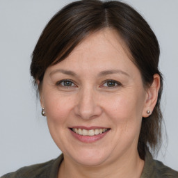 Joyful white adult female with medium  brown hair and brown eyes