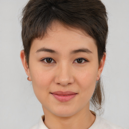 Joyful asian young-adult female with short  brown hair and brown eyes