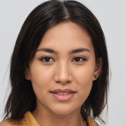 Joyful asian young-adult female with medium  brown hair and brown eyes