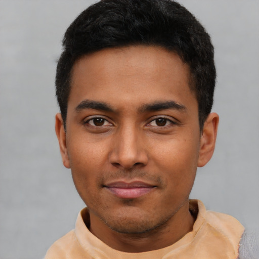 Joyful latino young-adult male with short  black hair and brown eyes