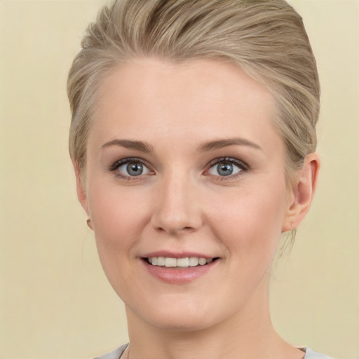 Joyful white young-adult female with short  blond hair and brown eyes