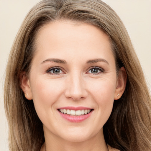 Joyful white young-adult female with long  brown hair and grey eyes