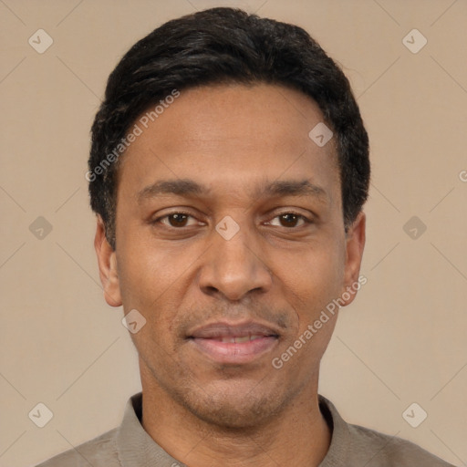 Joyful latino adult male with short  black hair and brown eyes