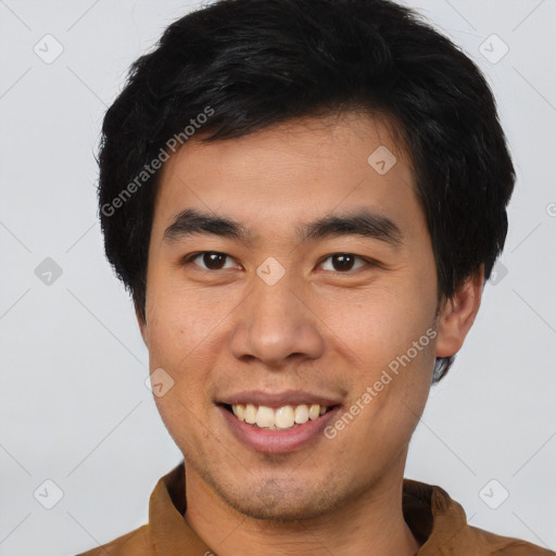 Joyful asian young-adult male with short  brown hair and brown eyes