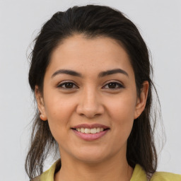 Joyful latino young-adult female with medium  brown hair and brown eyes