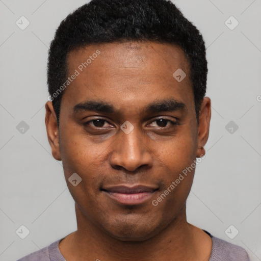 Joyful black young-adult male with short  black hair and brown eyes