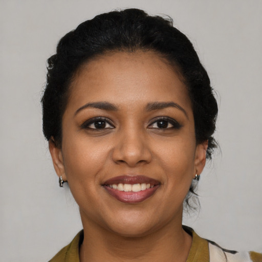 Joyful black young-adult female with medium  brown hair and brown eyes