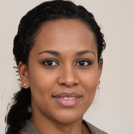 Joyful black young-adult female with medium  black hair and brown eyes