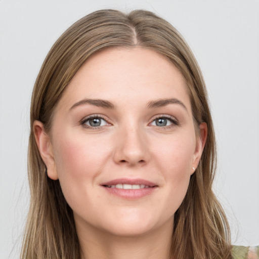 Joyful white young-adult female with long  brown hair and grey eyes