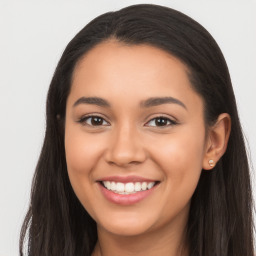 Joyful latino young-adult female with long  brown hair and brown eyes