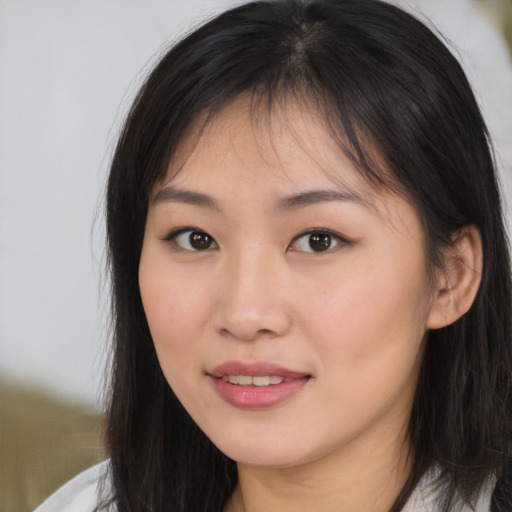 Joyful asian young-adult female with long  brown hair and brown eyes