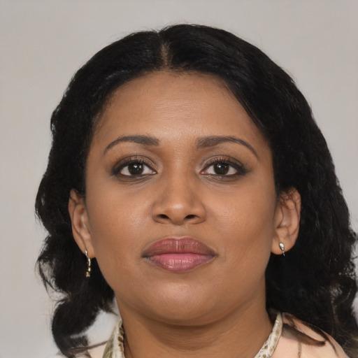Joyful black young-adult female with medium  brown hair and brown eyes