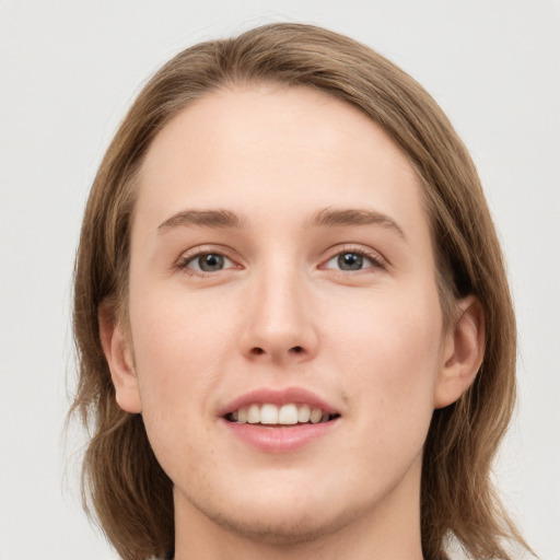 Joyful white young-adult female with medium  brown hair and grey eyes