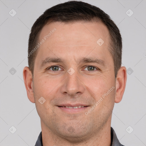 Joyful white adult male with short  brown hair and brown eyes