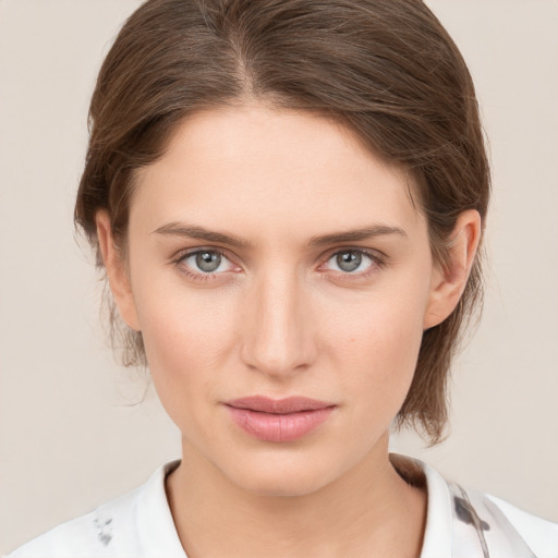 Joyful white young-adult female with medium  brown hair and grey eyes