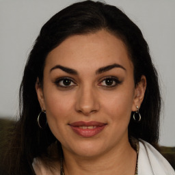 Joyful latino young-adult female with long  brown hair and brown eyes