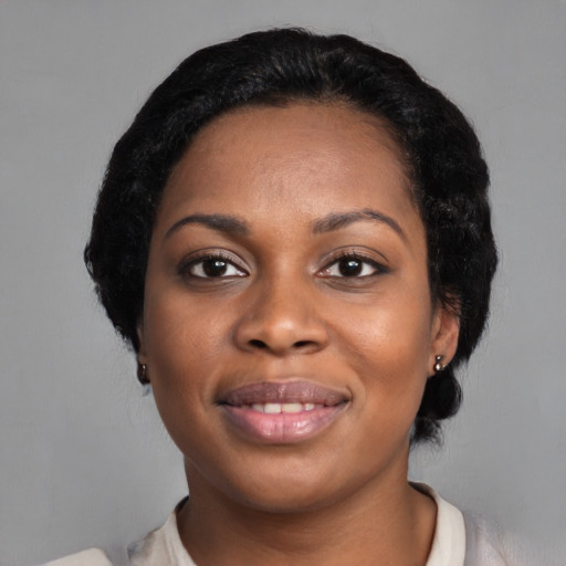 Joyful black young-adult female with medium  black hair and brown eyes