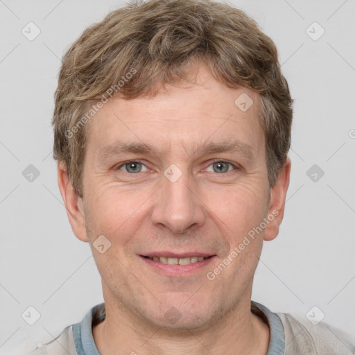 Joyful white adult male with short  brown hair and grey eyes