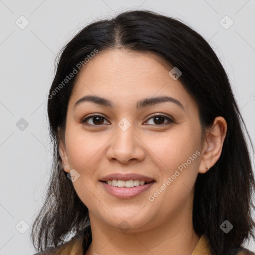 Joyful latino young-adult female with long  brown hair and brown eyes