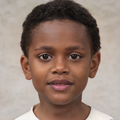 Joyful black child male with short  brown hair and brown eyes