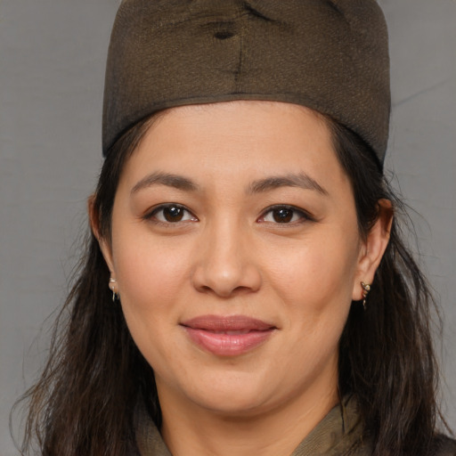 Joyful latino young-adult female with medium  brown hair and brown eyes