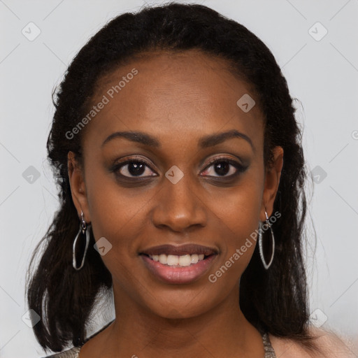 Joyful black young-adult female with long  brown hair and brown eyes