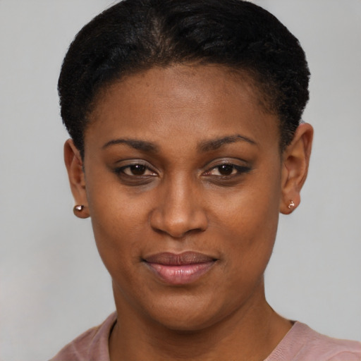 Joyful black young-adult female with short  black hair and brown eyes