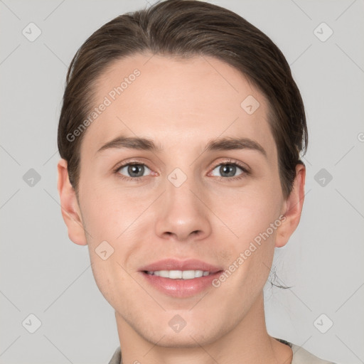 Joyful white young-adult female with short  brown hair and grey eyes