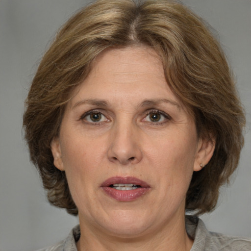 Joyful white adult female with medium  brown hair and brown eyes