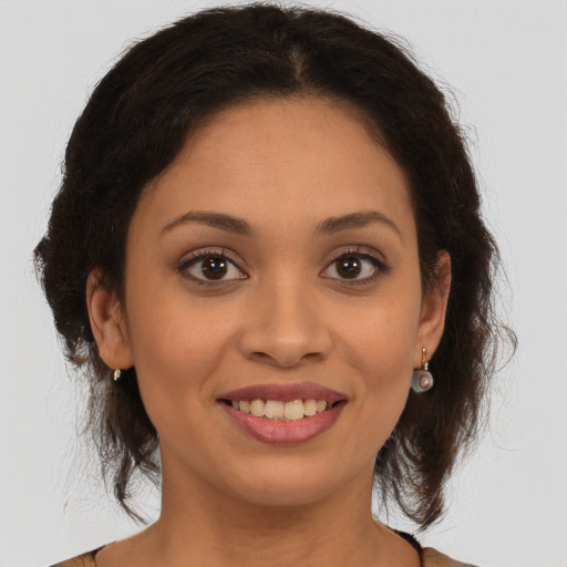 Joyful latino young-adult female with long  brown hair and brown eyes