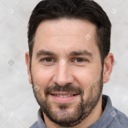 Joyful white adult male with short  brown hair and brown eyes