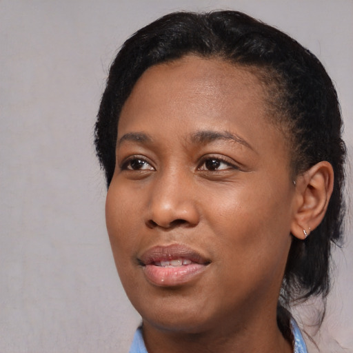 Joyful black young-adult female with short  black hair and brown eyes