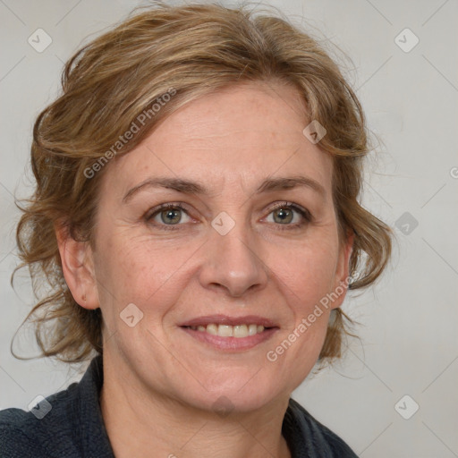 Joyful white adult female with medium  brown hair and blue eyes